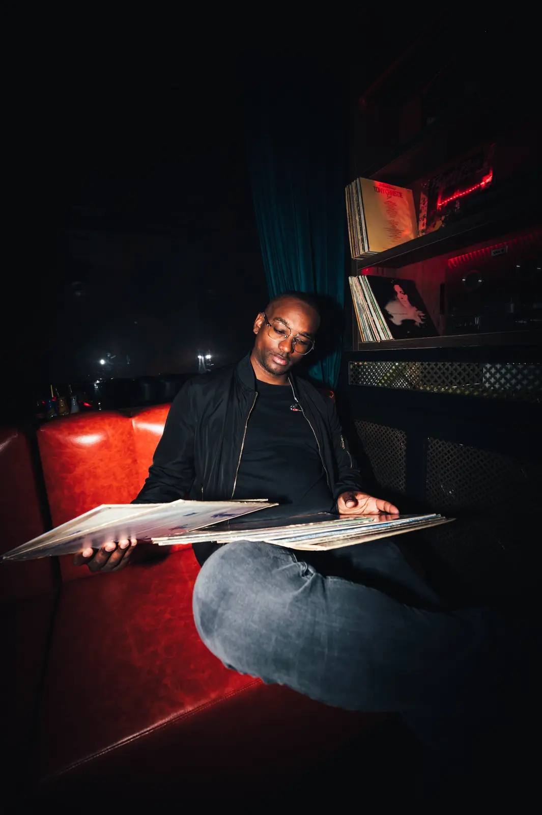 Hurrican X seated with vinyl records